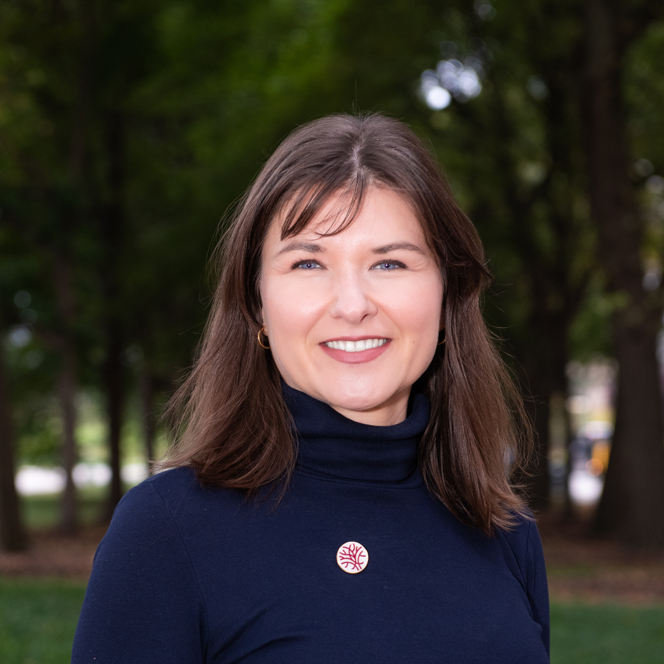 Headshot of Openlands' Vice President of Land Conservation and Policy Emily Reusswig with trees in the background