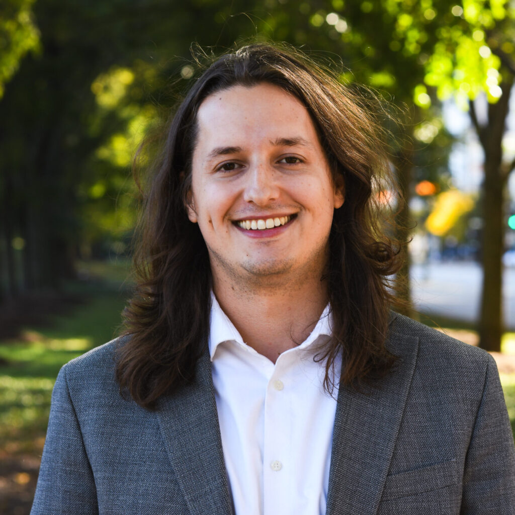 Headshot of Openlands' Restoration Coordinator Chris Bourbois with trees in the background