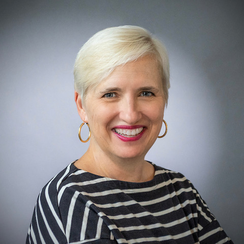 A headshot of Openlands Board memberMartina Keller. A woman standing in front of a grey background.