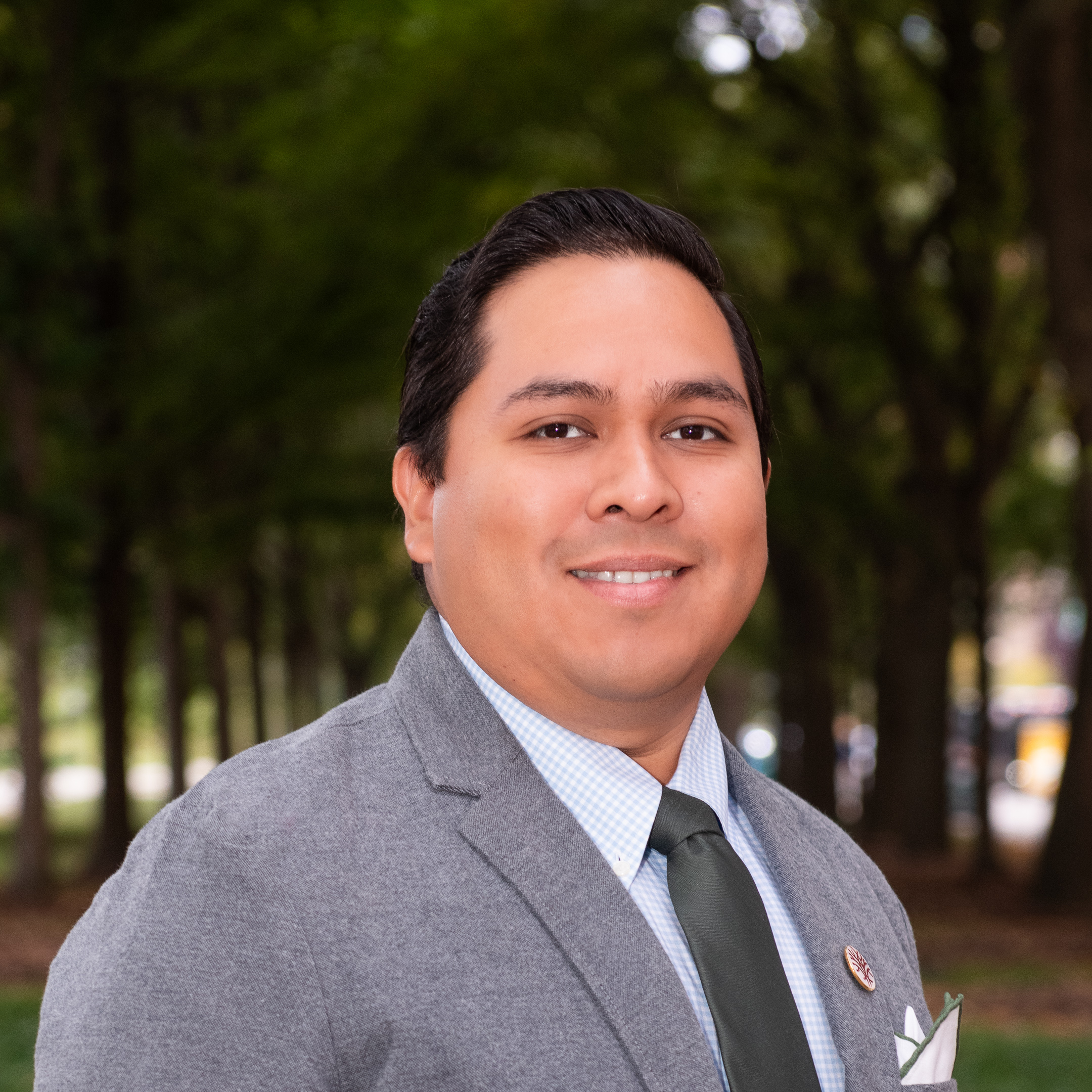 Headshot Openlands orestry Program Specialist Tonatiú Rodríguez with trees in the background