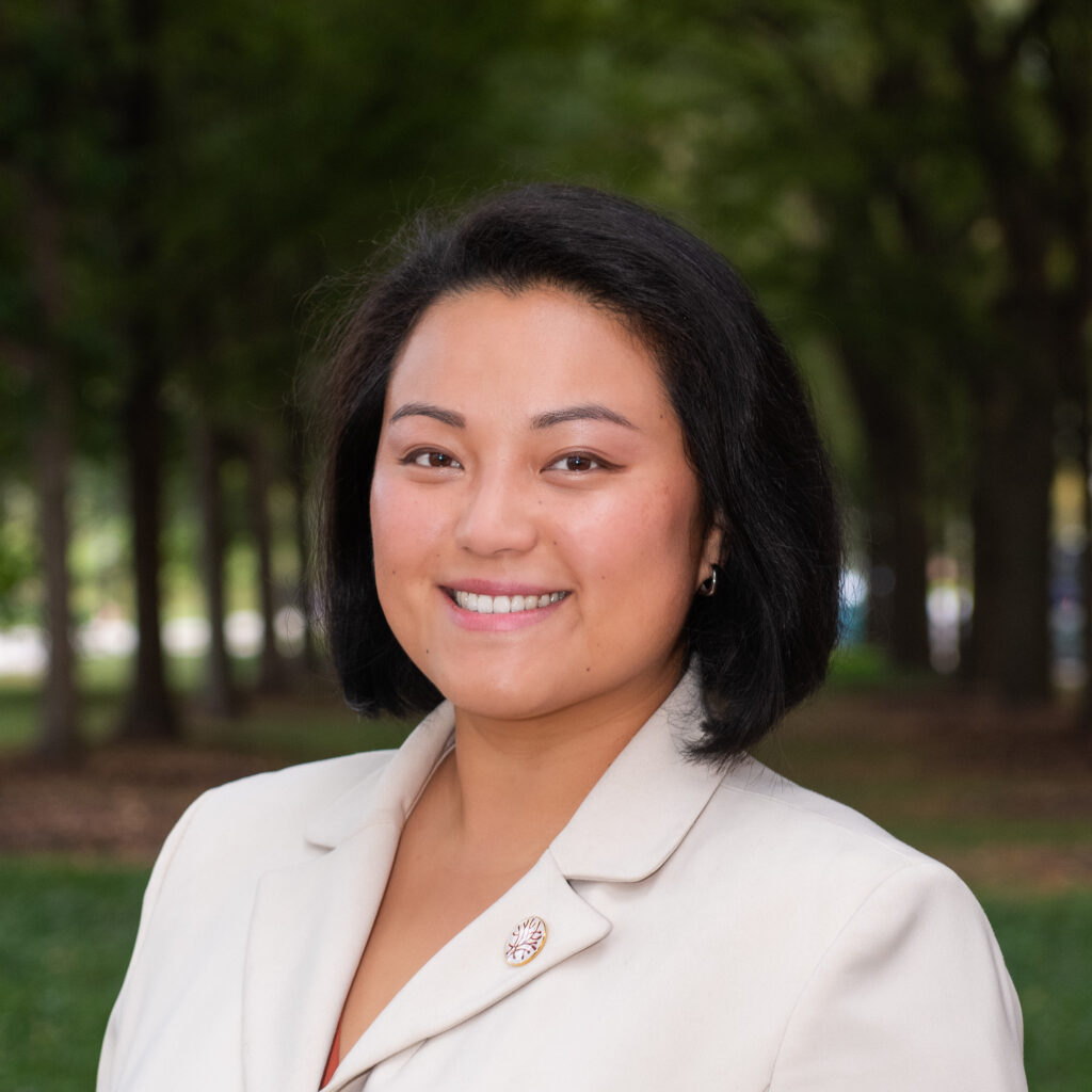 Headshot of Openlands' Vice President of External Affairs Huan Song with trees in the background