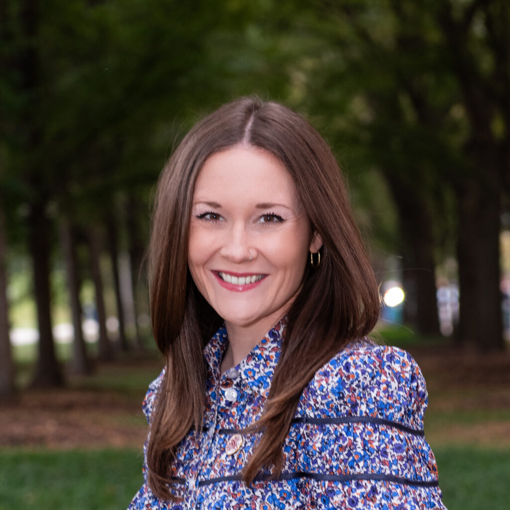 Headshot of Openlands Forestry Specialist Molly Scallon with trees in the background
