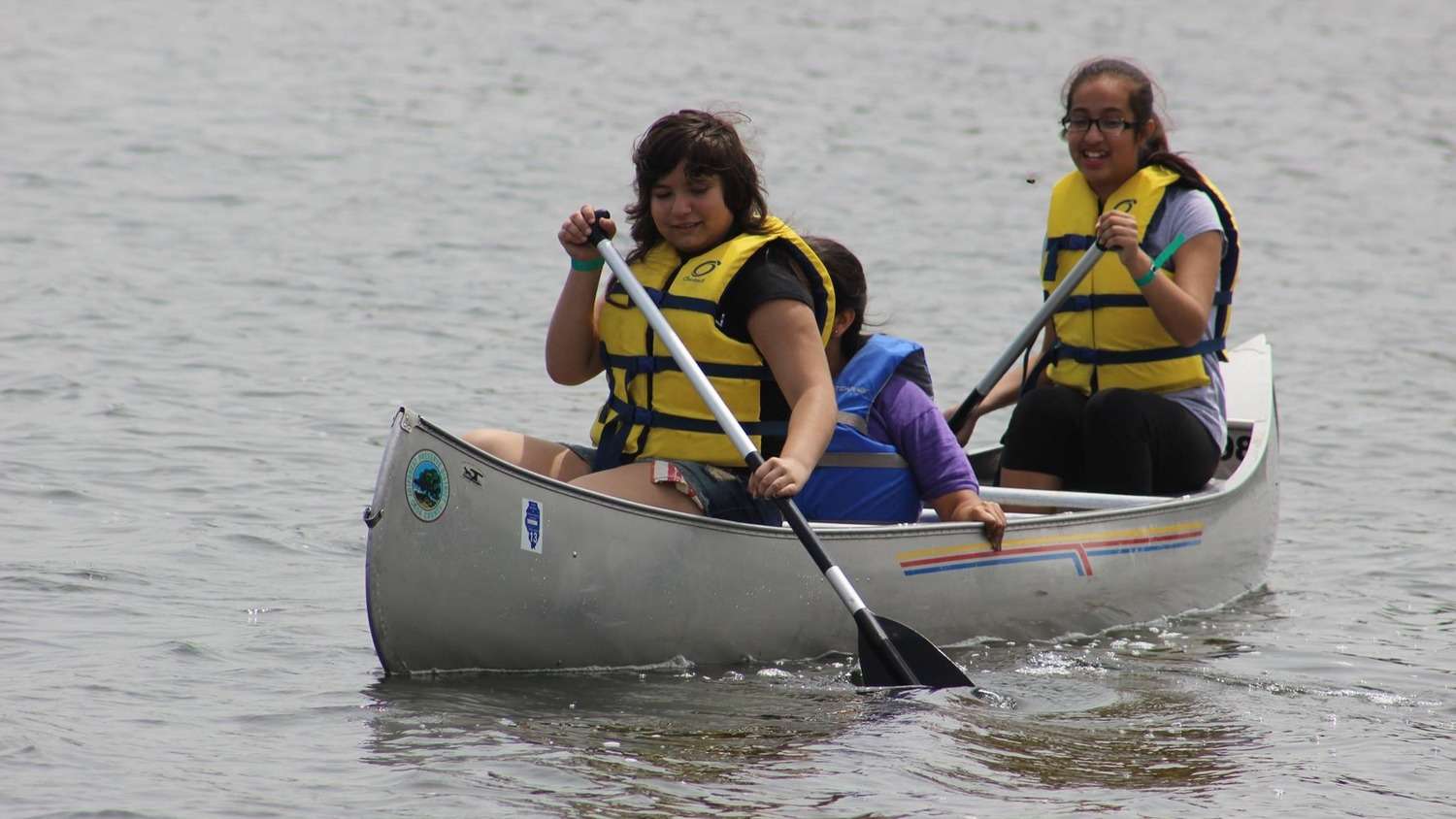 Two women in a canoe paddling on the water