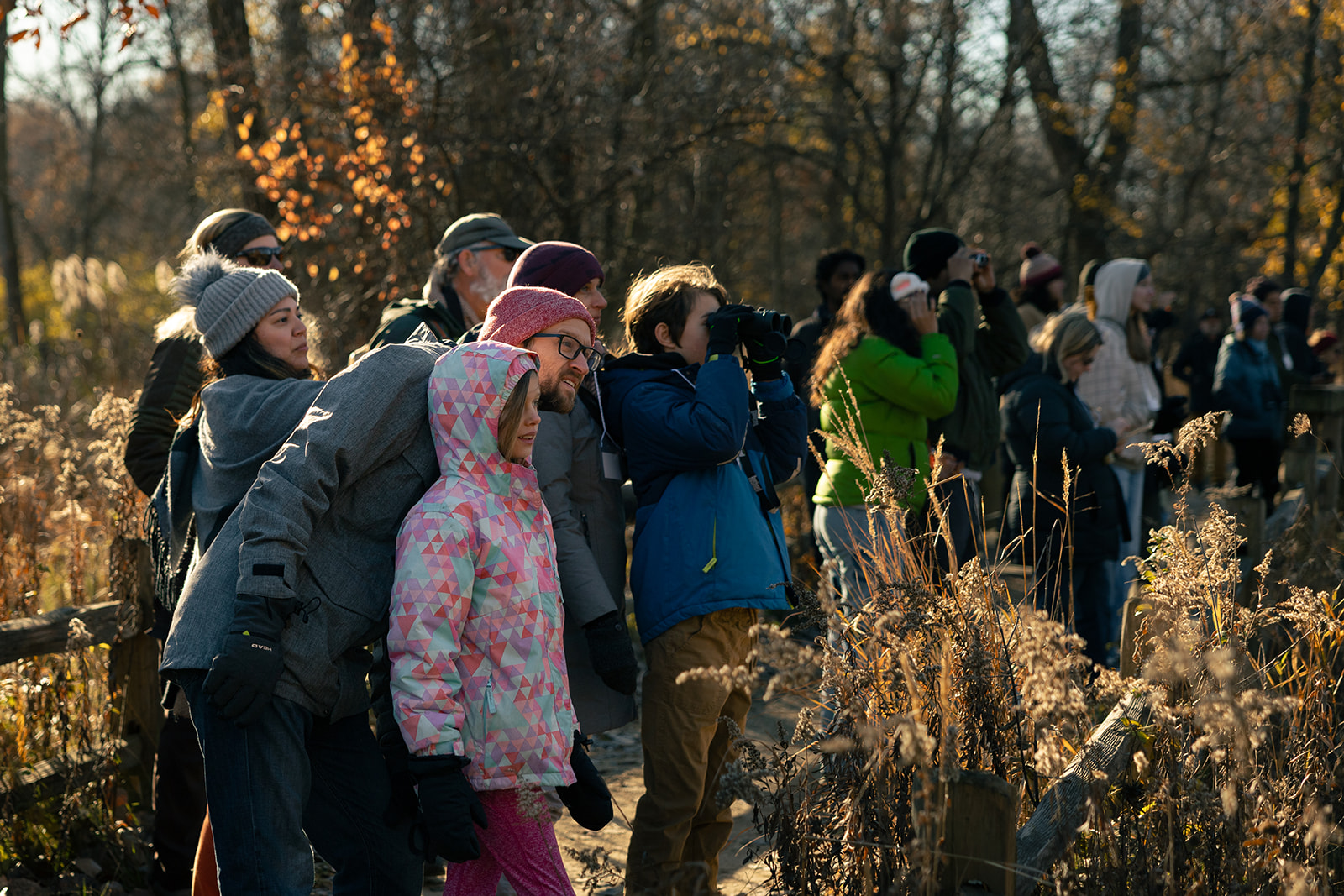 a group of people standing together in a forest