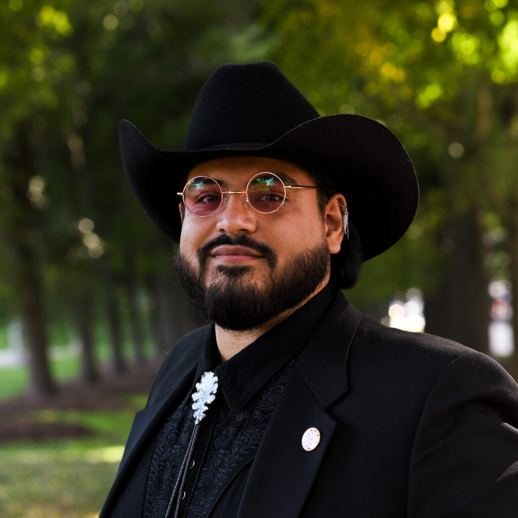 a bearded man wearing a hat and glasses