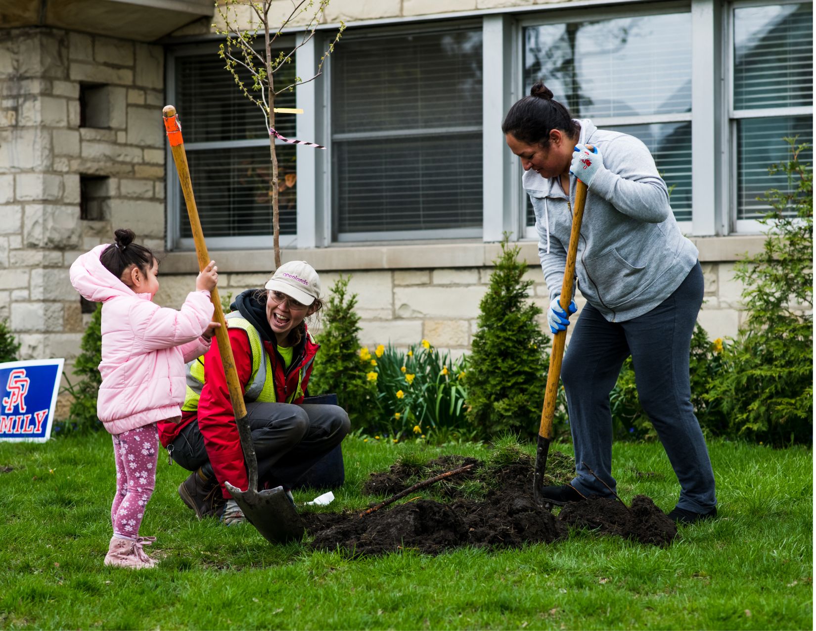 Katie Fleming planting a tree in The Little Village