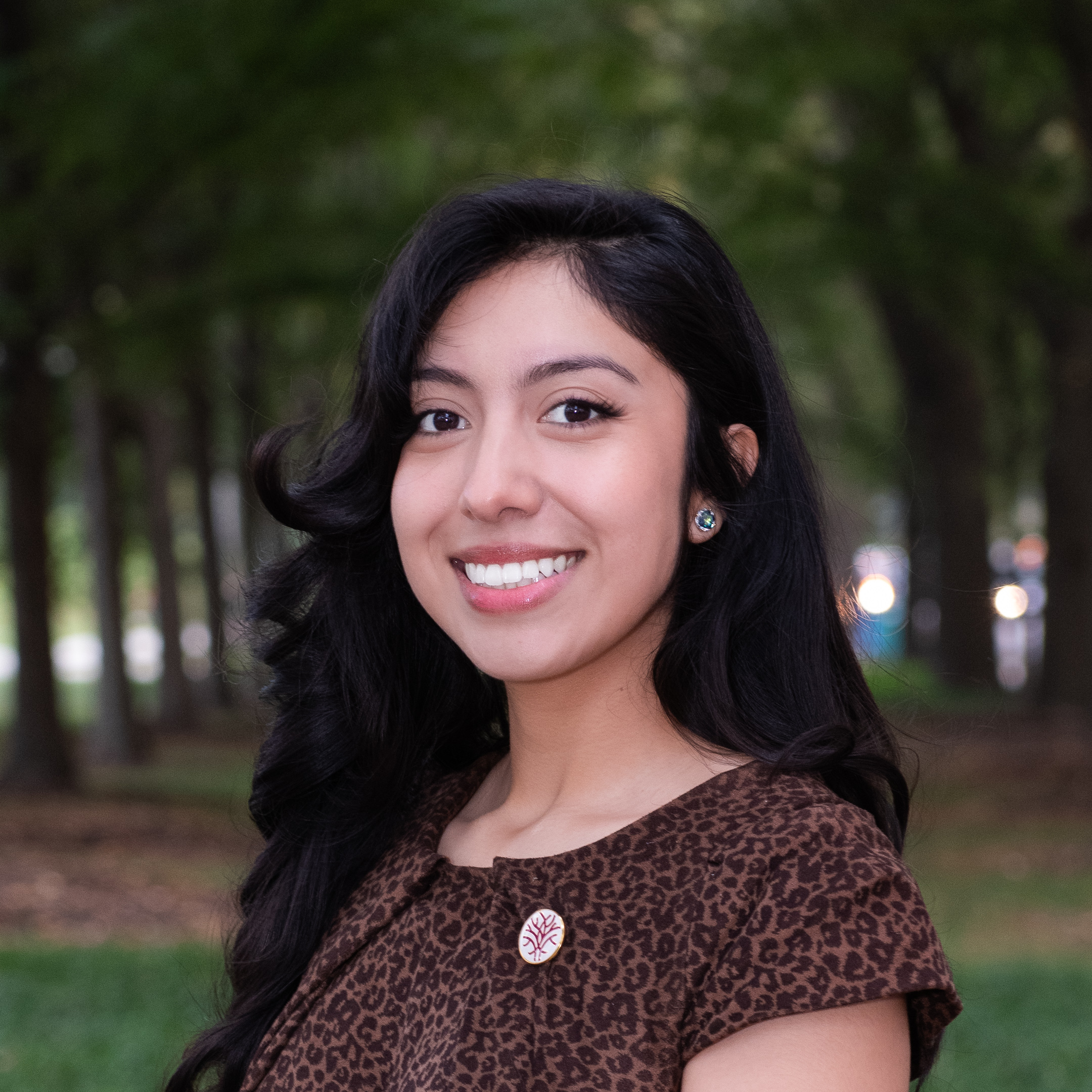Headshot Openlands Forestry Coordinator Specialist Leslie Leon-Aguilar with trees in the background