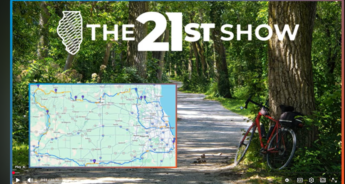 Title "The 21st Show" with bike trail in the background.